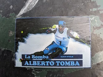 A sticker featuring a photograph of the famous Italian alpine skier Alberto Tomba. The sticker includes his nickname, "La Bomba", and the text "DJGN STHLM".