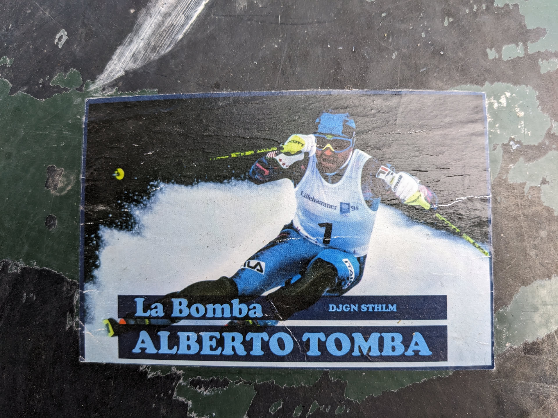 A sticker featuring a photograph of the famous Italian alpine skier Alberto Tomba. The sticker includes his nickname, "La Bomba", and the text "DJGN STHLM".