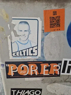 A sticker featuring a stylized image of a bald Celtics player.  The text 'CELTICS' is prominently displayed, along with 'MONTROSS ZERO CENTER' underneath. There is also a small QR code sticker nearby.