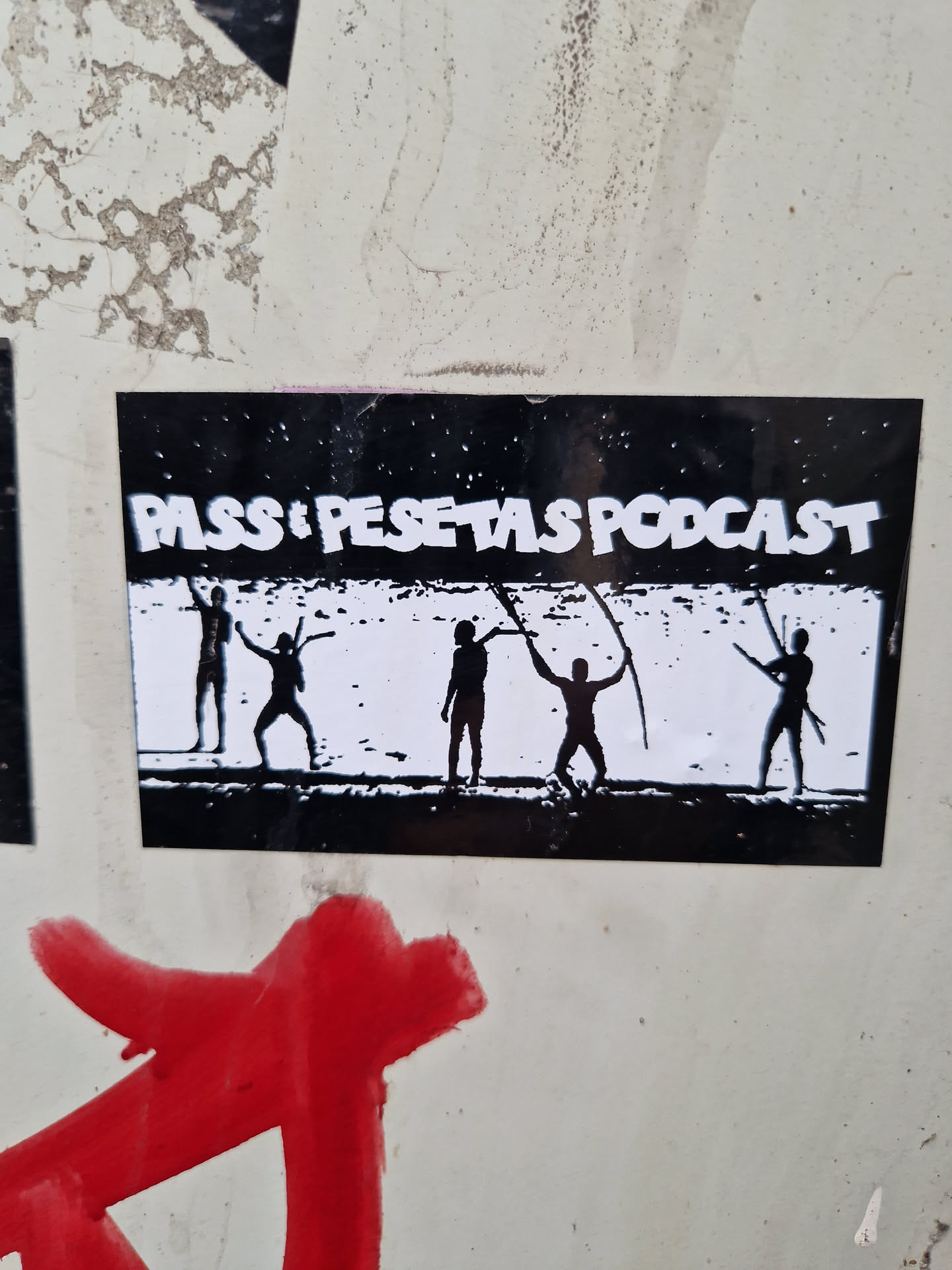Black and white sticker with the text "Passos Pesetas Podcast" and an image of five silhouetted figures seemingly dancing or performing a ritual.