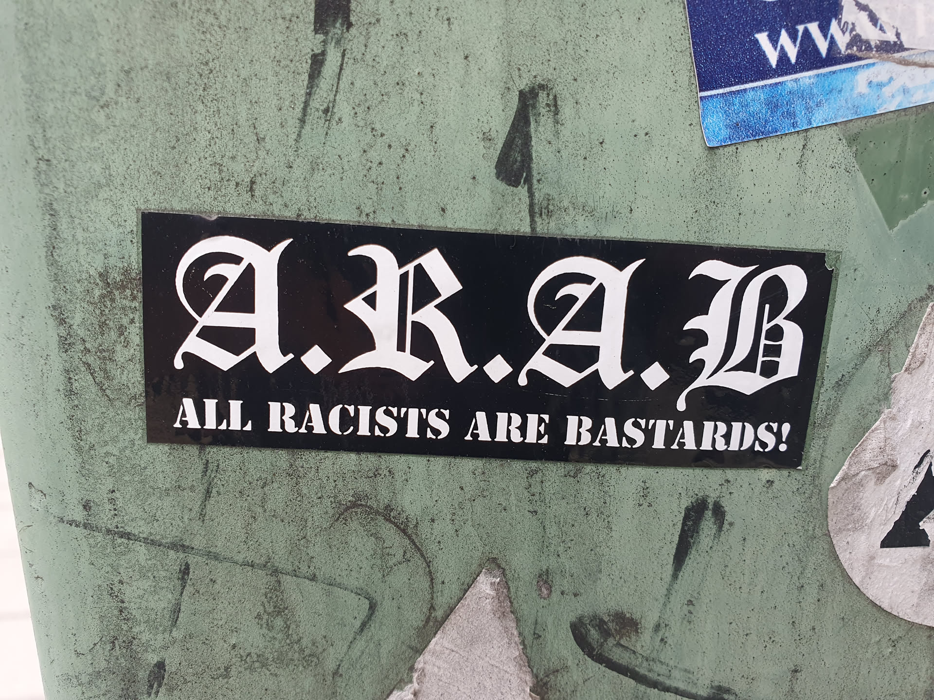 A black and white sticker with the acronym A.R.A.B. standing for All Racists Are Bastards! The text is written in an old English style font.