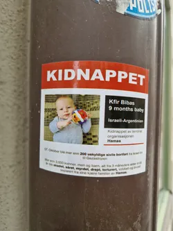 A sticker showing a picture of a 9 months old baby, Kfir Bibas, who was kidnapped by Hamas.  The sticker also mentions that over 200 innocent civilians were abducted and over 3000 women and children were hurt, killed, or separated from their families.