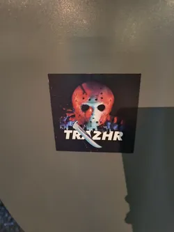 A sticker featuring Jason Voorhees' hockey mask and machete from the Friday the 13th franchise. The word TRZHR is printed below the image.