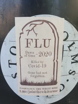 A tombstone-shaped sticker commemorating the 'death' of the flu in 2020, attributing it to Covid-19.  The sticker is beige with brown text and graphic, and includes a Telegram social media link at the bottom.