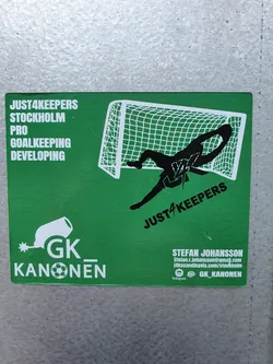 Green sticker with a goalkeeper diving to save a goal.  It also features the logo for GK_Kanonen and contact info for Stefan Johansson.