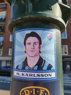 A sticker featuring a portrait of M. Karlsson, possibly a football player, with the DIEF logo. The style is reminiscent of retro sports trading cards.