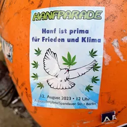 A sticker promoting the Hanfparade in Berlin, Germany. It features a dove carrying a cannabis leaf, with the date and location of the event.