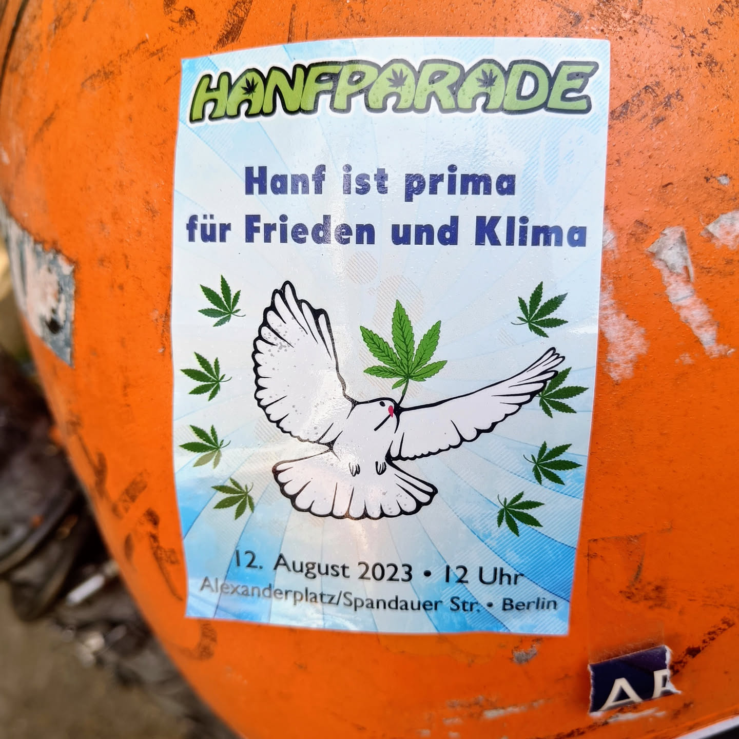 A sticker promoting the Hanfparade in Berlin, Germany. It features a dove carrying a cannabis leaf, with the date and location of the event.