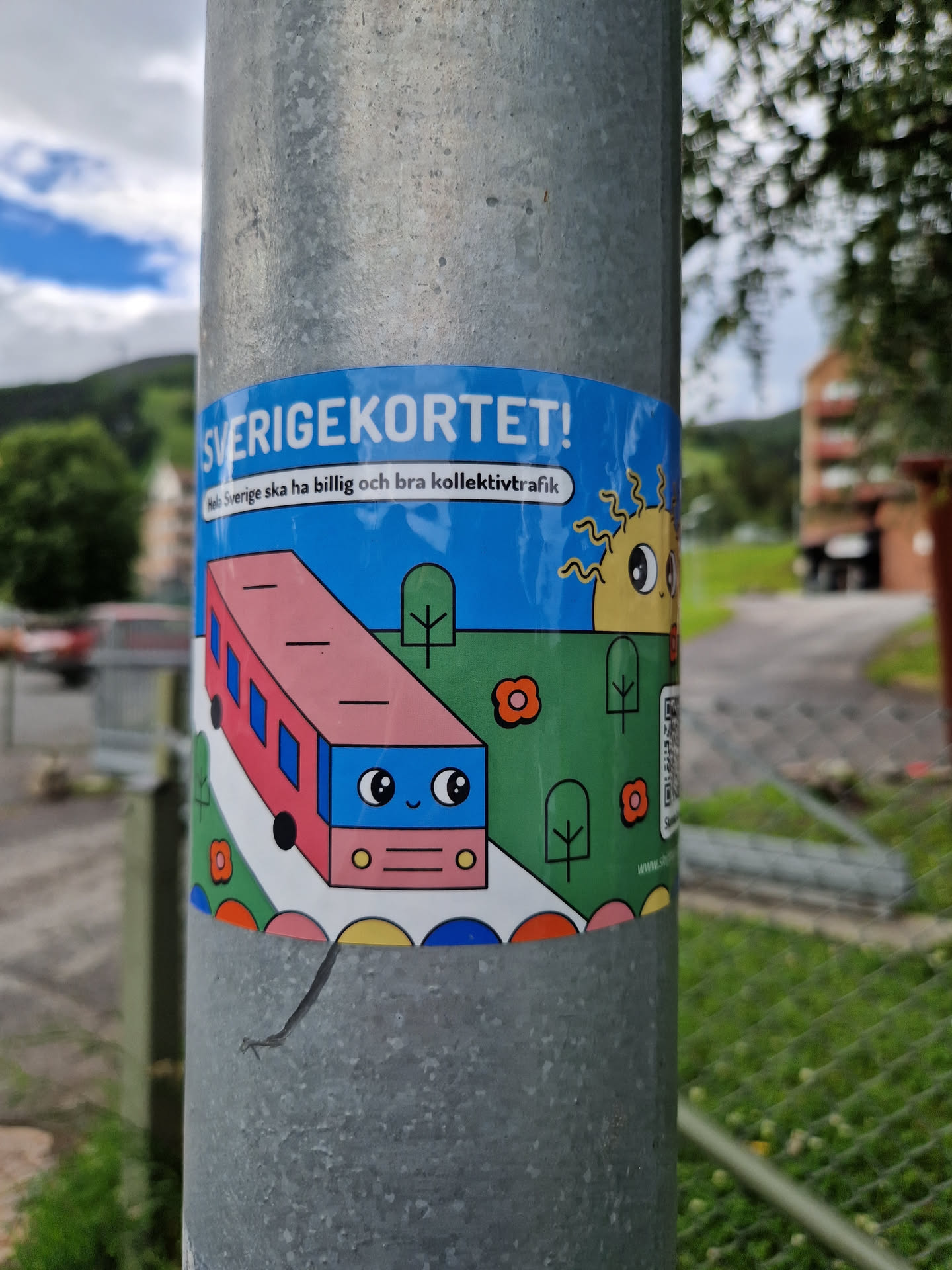 A cute sticker advocating for affordable and good public transport in Sweden.  It features a cartoon bus and sun. A QR code is included, but the URL is not easily readable from the image.