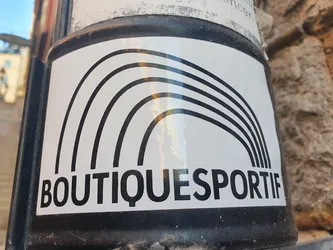 The sticker features a stylized rainbow made of five bold black arcs on a white background. Below the rainbow, the text "BOUTIQUESPORTIF" is printed in a sans-serif font.