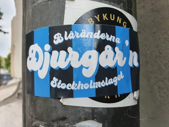 A blue and black striped sticker with the words "Djurgården" in a stylized white font. Smaller text above and below reads "Blåränderna" and "Stockholmslaget".