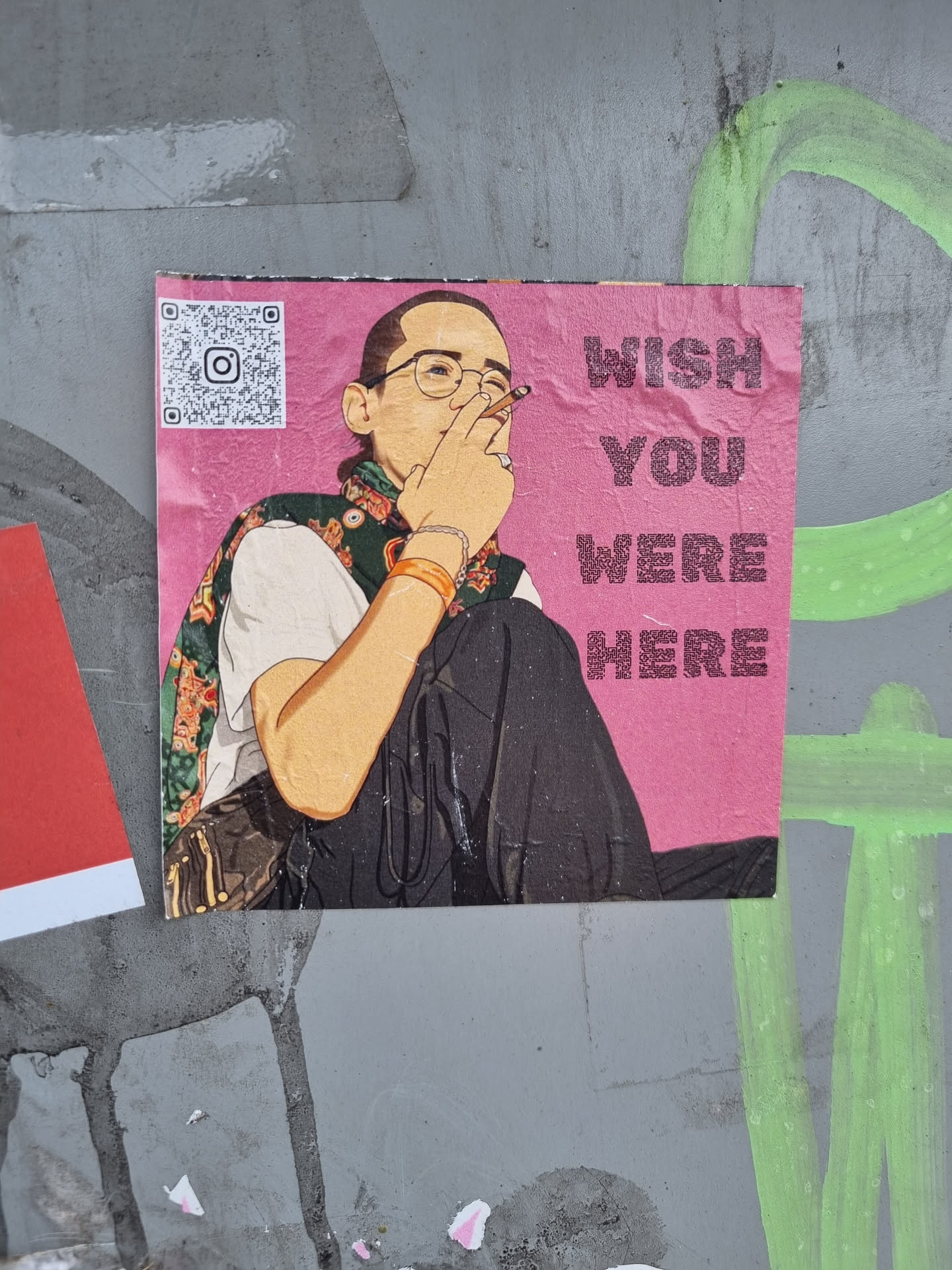 A sticker featuring an illustration of a person smoking a cigarette with the text 'Wish You Were Here'.  The sticker has a pink background and includes a QR code linking to Instagram.
