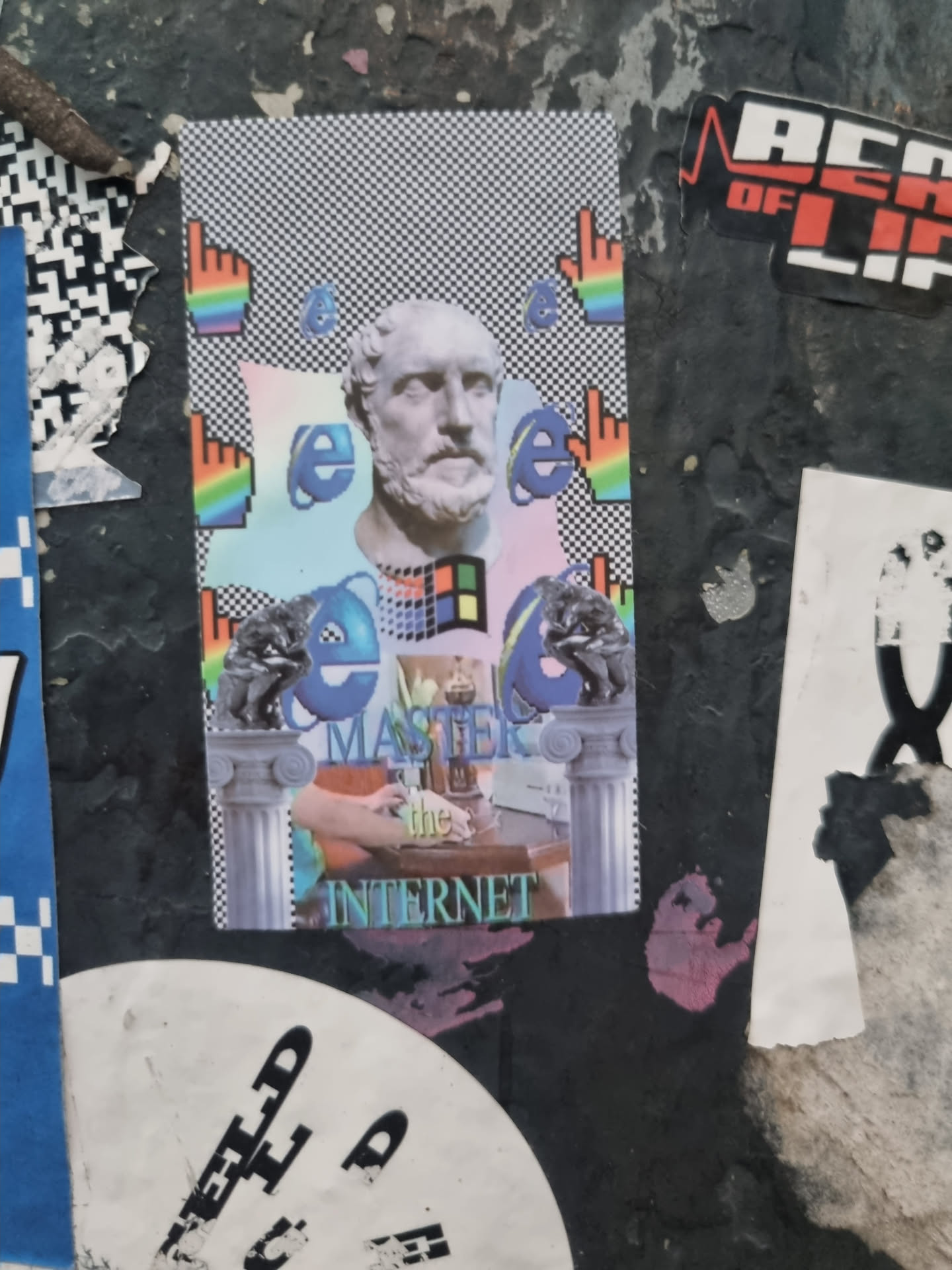 A sticker featuring a bust of a Greek philosopher superimposed with the Internet Explorer logo and other digital elements. The sticker has a retro aesthetic with pixel art and a color scheme reminiscent of the early internet era.