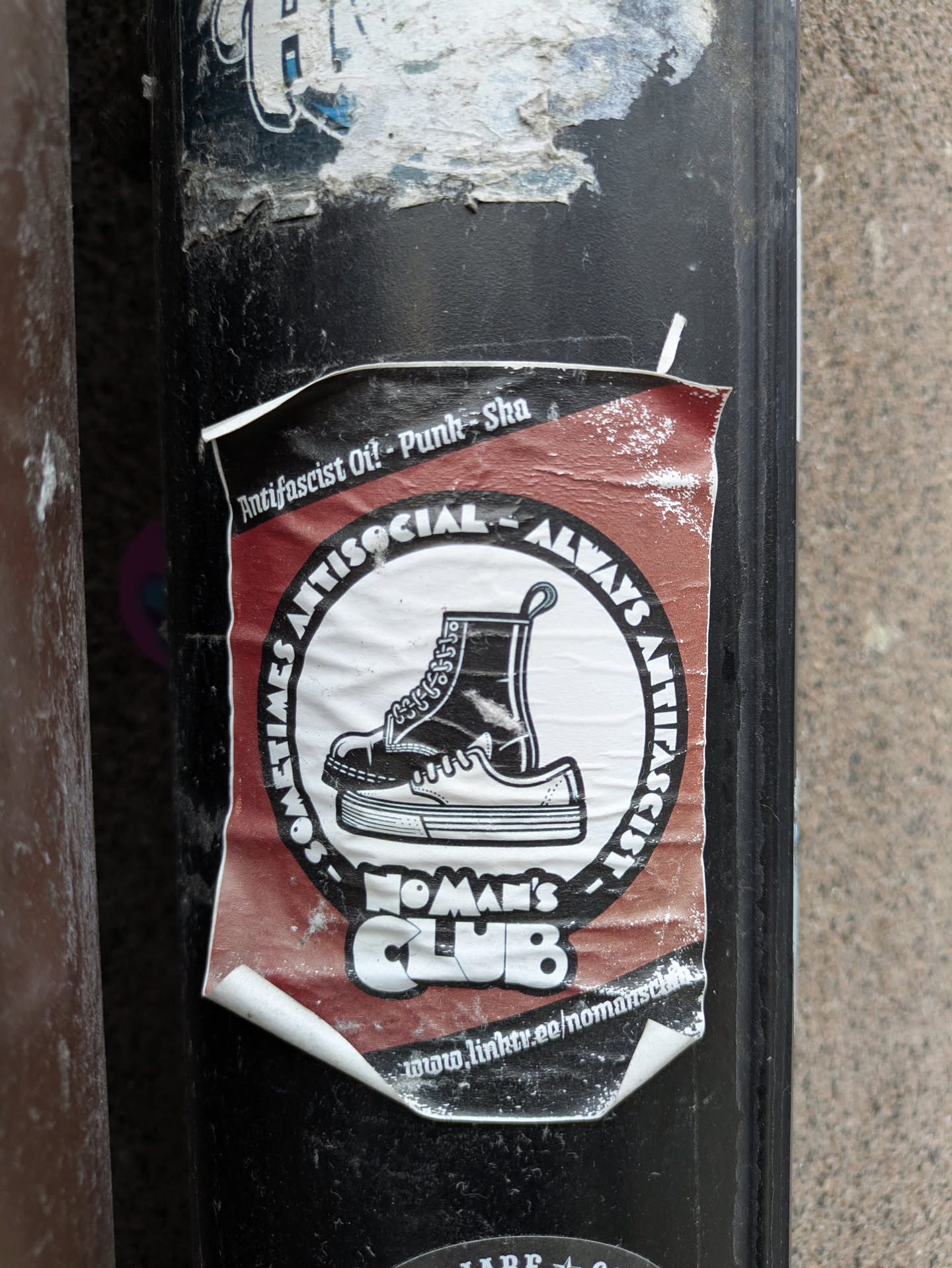 Sticker from No Man's Club with an illustration of boots and the text Sometimes Antisocial Always Antifascist. The sticker includes a link to the club's Linktree profile.
