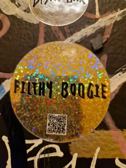 A round, holographic gold sticker with the text "Filthy Boogie" in black. It features a QR code at the bottom. 