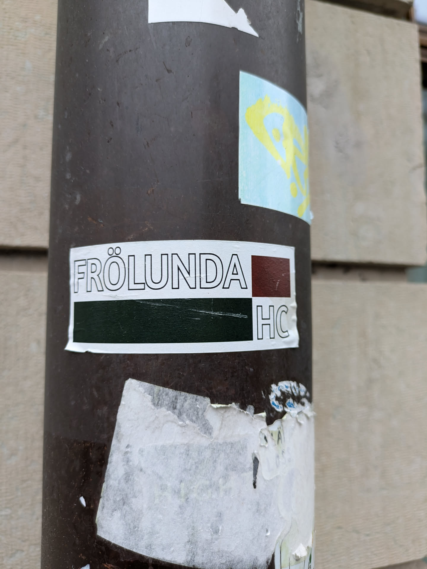 A simple yet striking sticker featuring the name "Frölunda HC" in a minimalist design. The color scheme is mainly dark green and maroon, with white text providing a clear contrast. It's likely representing a hockey club or team.