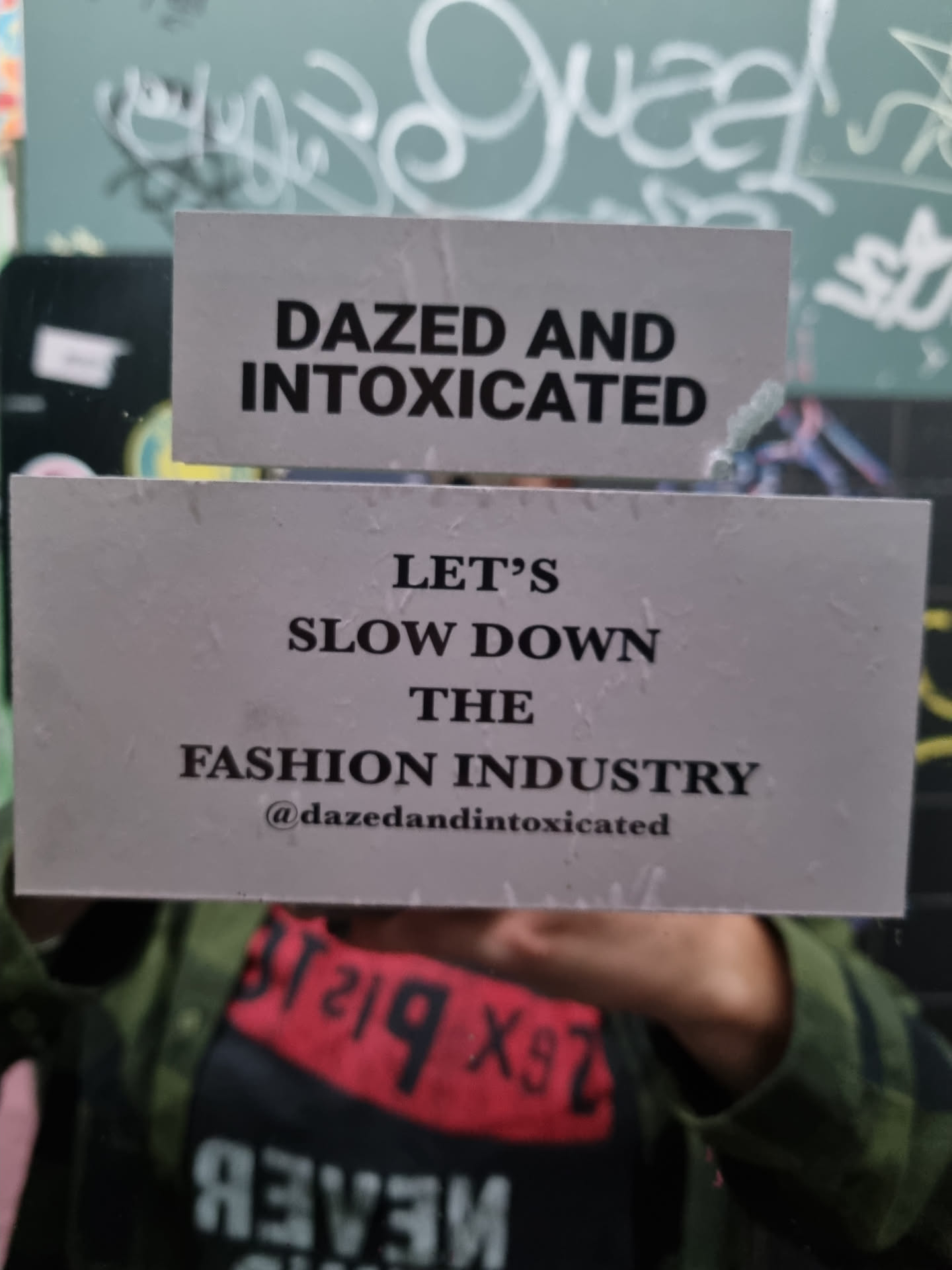 A sticker with a message advocating for slowing down the fashion industry.  It's from the brand Dazed and Intoxicated.