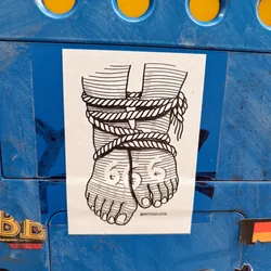 A black and white illustration of two feet bound by rope.  The style is reminiscent of old anatomical drawings. The sticker is affixed to a blue surface. There is an Instagram handle at the bottom.