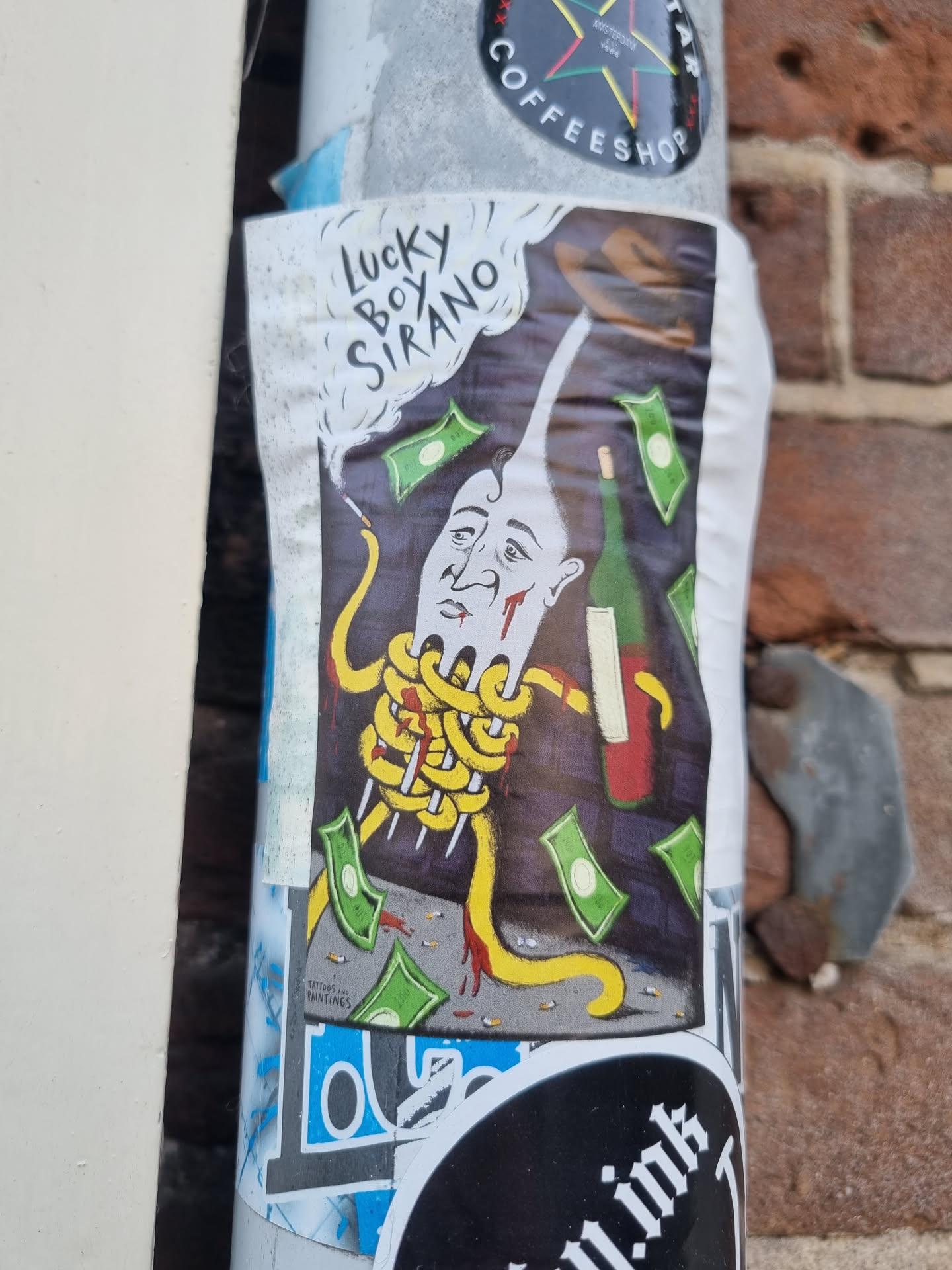 A colorful sticker featuring a cartoon illustration of a man's head entangled in spaghetti, with money falling around him.  A wine bottle is also present. The words "Lucky Boy Sirano" are written in the top left corner of the sticker.
