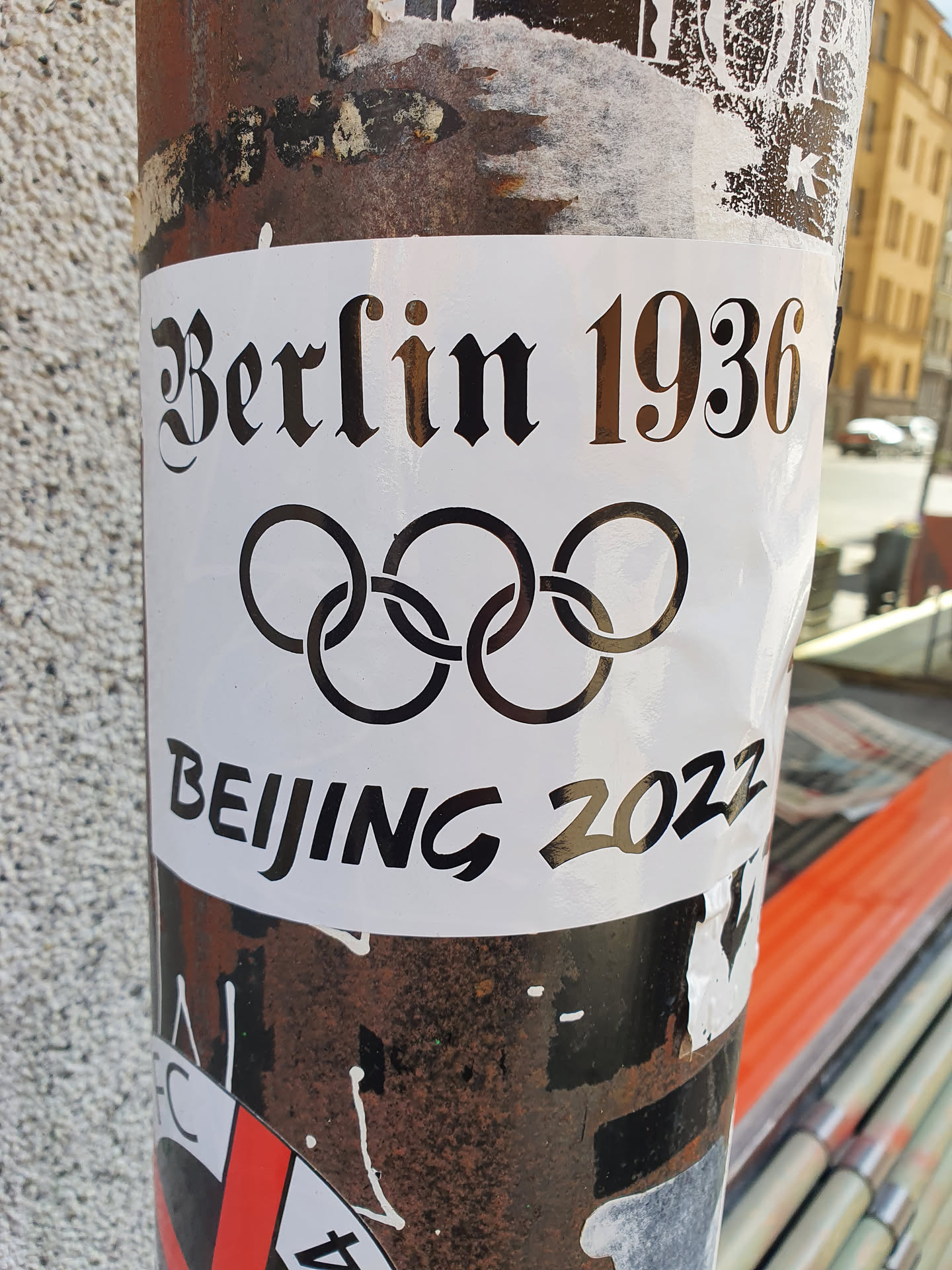 A sticker featuring the Olympic rings and the years 1936 and 2022, representing the Olympic Games held in Berlin and Beijing. The text "Berlin 1936" is in a black old English font, while "Beijing 2022" is in a more modern sans-serif font.