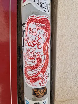 A red and white sticker featuring a detailed illustration of a dragon. The style is reminiscent of traditional Asian tattoo art.  The sticker has the text "@jerome.tattoos" at the bottom.
