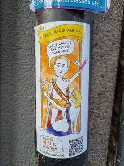 A sticker featuring a cartoon drawing of a king and a queen with sex toys.  The sticker includes a QR code that links to a contest to win a "royal toy".