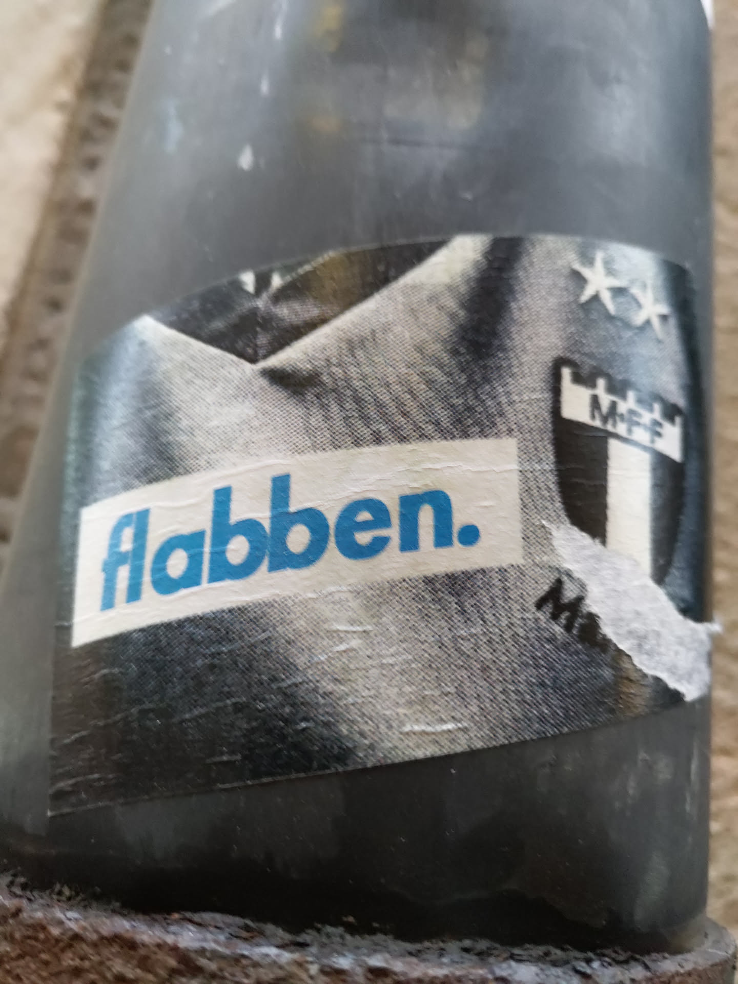 A monochrome sticker featuring a stylized image of a soccer jersey with a crest and the word 'flabben.' in a bold blue font. The style is reminiscent of vintage sportswear or fan art.