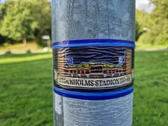 A sticker featuring an illustration of Stockholms Stadion, built in 1912. The sticker has a dark blue background and is bordered in blue. The text 'Stockholms Stadion 1912' is visible at the bottom.