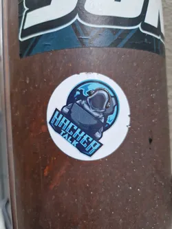A round sticker featuring a logo of a hooded figure sitting in front of a laptop with a globe in the background. The text "Hacker Talk" is written vertically on the sticker.