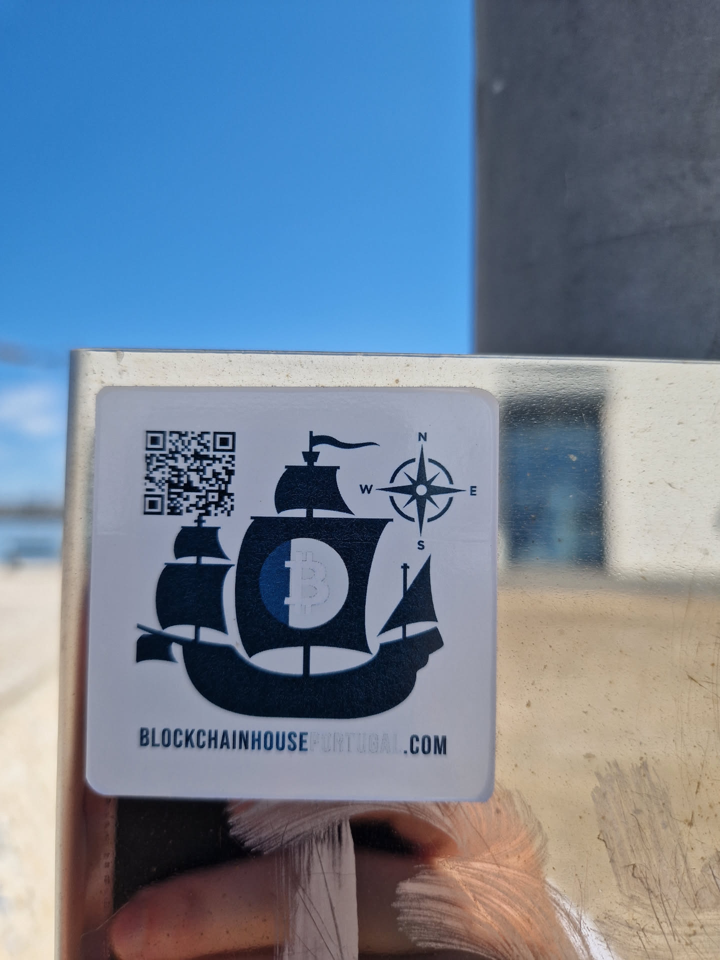 Sticker featuring a ship with a Bitcoin logo on its sail, a compass, and a QR code.  The text at the bottom reads "BLOCKCHAINHOUSE PORTUGAL.COM"