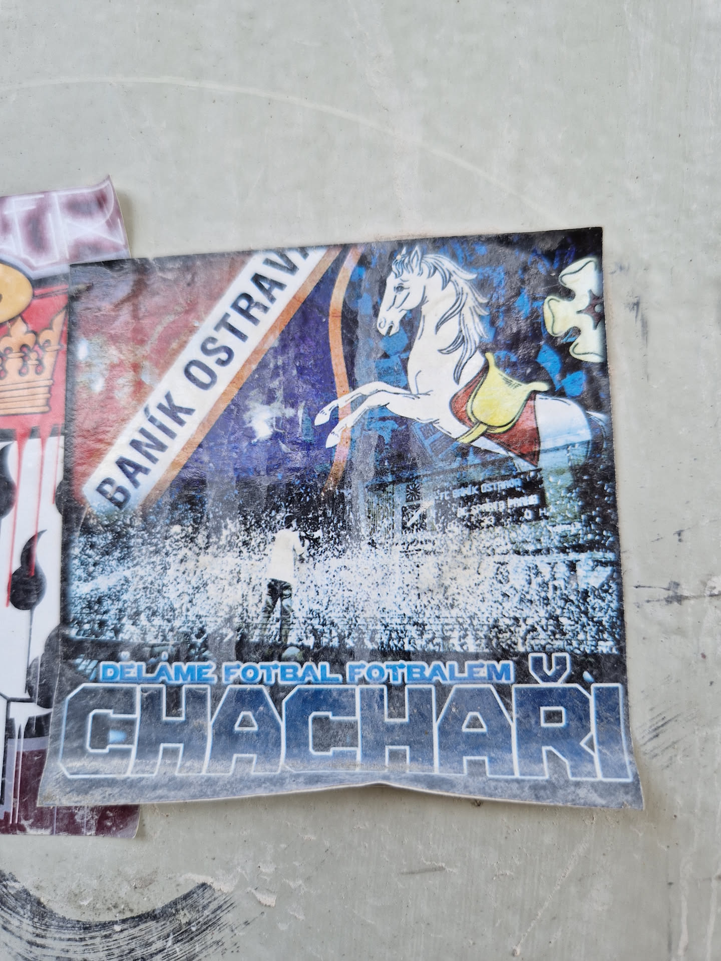 A sticker featuring a white horse, a football stadium, and the text "Chachari" and "Baník Ostrava". The text at the bottom reads "Delame fotbal fotbalem v".