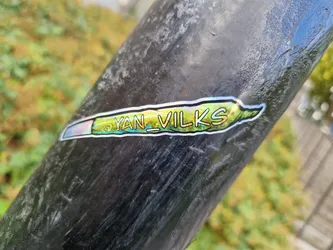 Holographic sticker of a joint with the text "YAN_VILKS" on it.