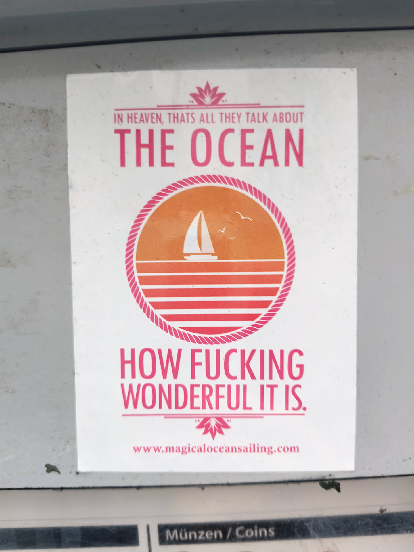 A sticker with a minimalist design featuring a sailboat at sunset and a bold statement about the ocean's wonder. It includes a website address, suggesting a connection to a business or brand related to sailing or ocean experiences. The color scheme is primarily white, orange, and pink.