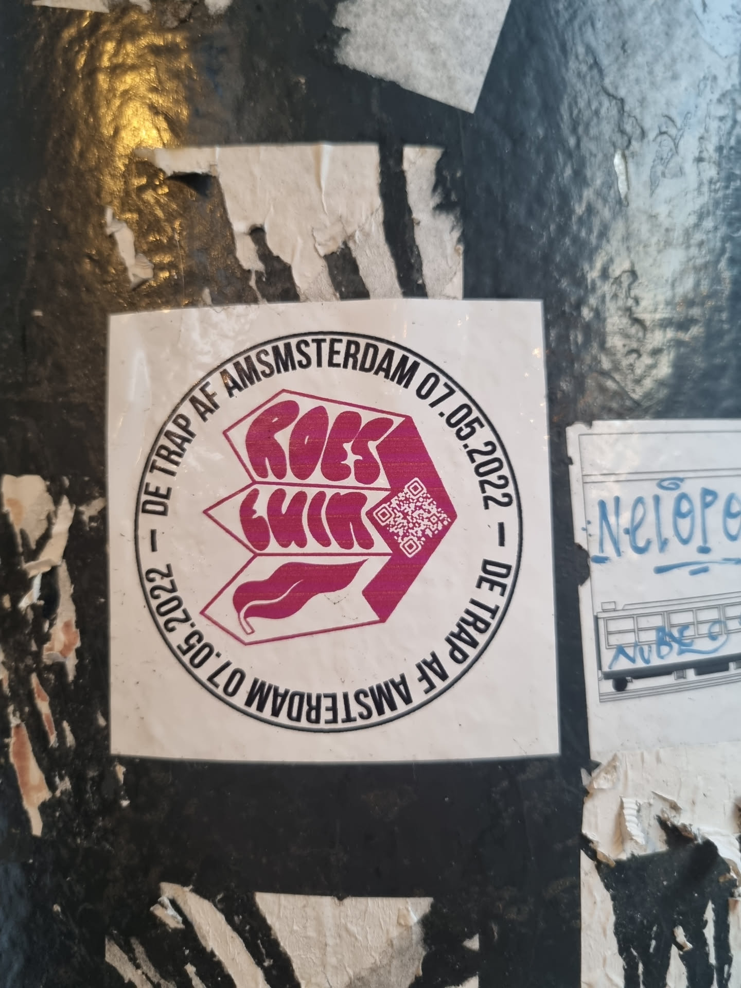 Circular sticker with the text 'Roest' in a stylized font, dates, and a QR code.  It appears to be an event announcement for Roest in Amsterdam on May 7th, 2022.