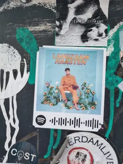 A sticker featuring the album art for Langzaam Haasten. The sticker includes a Spotify code.
