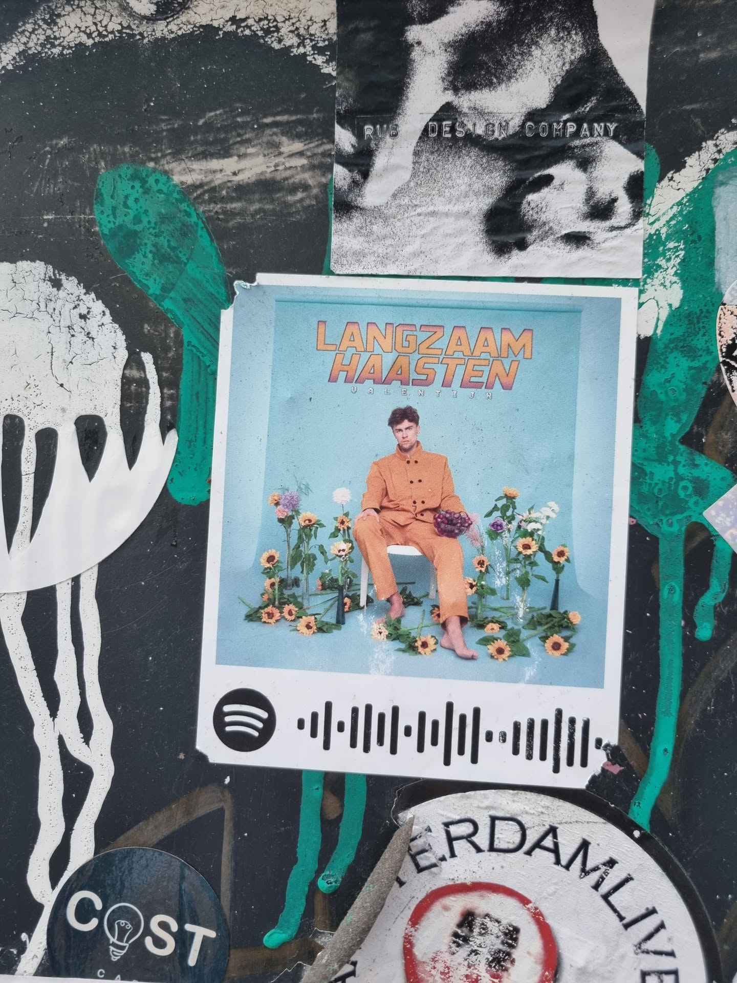 A sticker featuring the album art for Langzaam Haasten. The sticker includes a Spotify code.