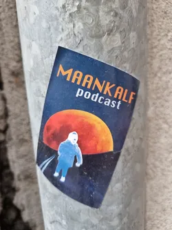 A sticker featuring the Maankalf podcast logo. The design includes an illustration of a child walking on a road towards a large orange moon. The color scheme is dark blue and orange.