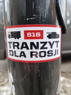 A sticker with a truck, the number S16, and a tank. The text on the sticker says "Tranzyt dla Rosji", which is Polish for "Transit for Russia".