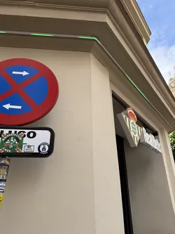A circular sticker featuring a vibrant green background with white elements. At its center is a stylized white mushroom with green spots. Arched above the mushroom, in white capital letters, is "KALAMATA CLUB". Below the mushroom, also in white capital letters and arched, is "GATE 13". The design has the appearance of a football club's crest or a fan group's emblem, with a slightly worn texture suggesting it's a physical sticker.
