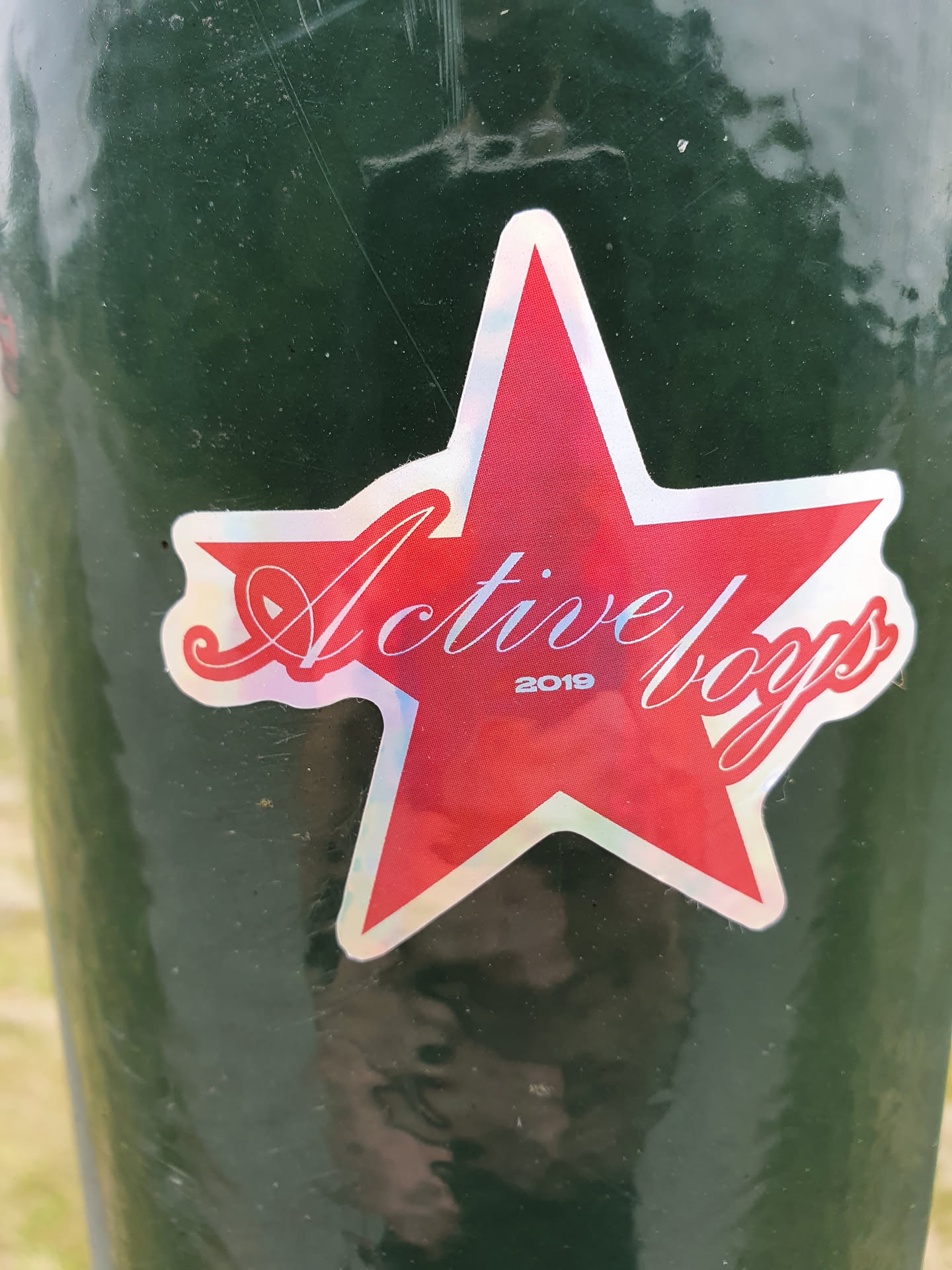 A red star-shaped sticker with the text "Active Boys" and the year 2019. The sticker has a slight iridescent quality.