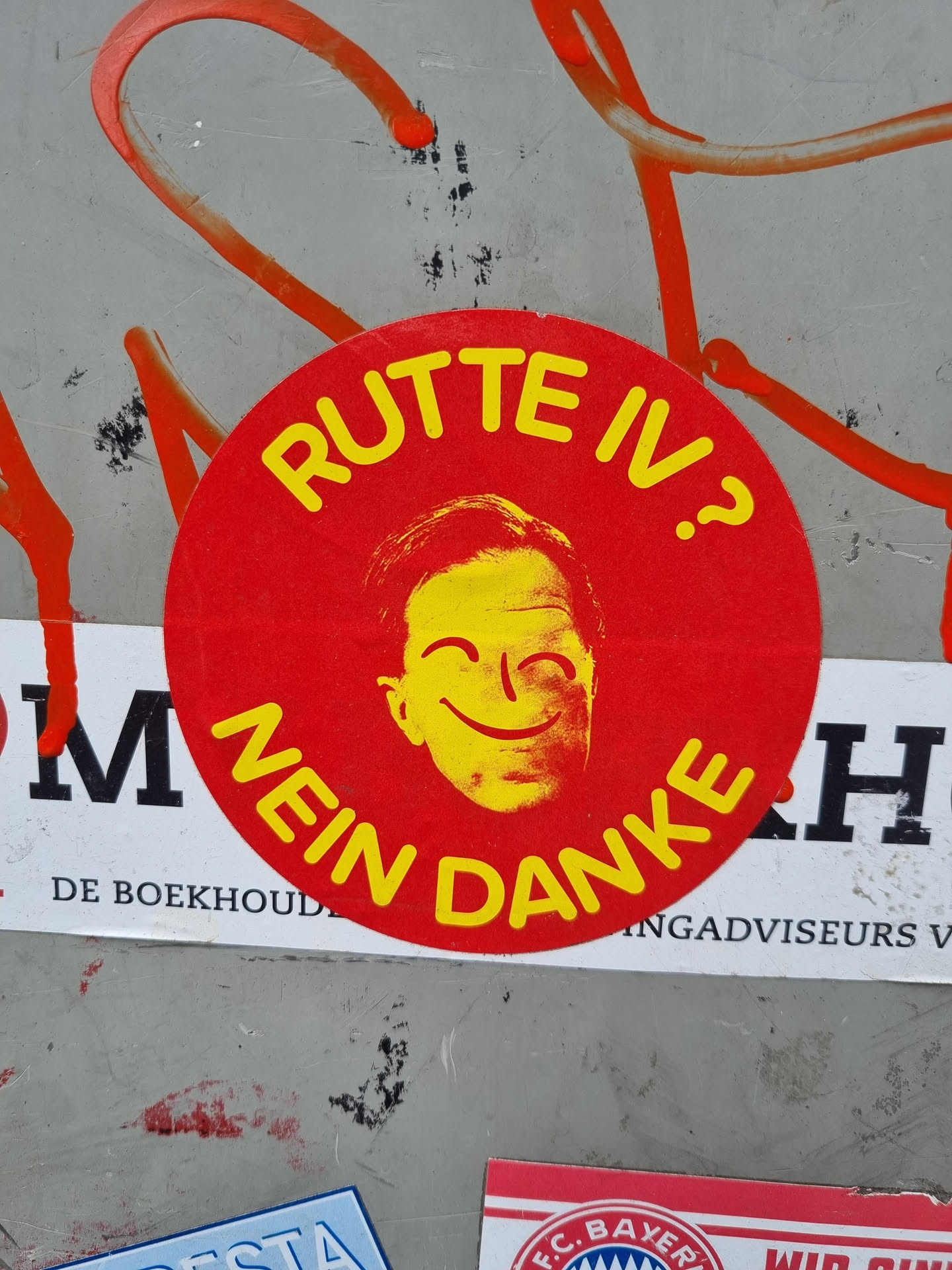 Red and yellow circular sticker with a caricature of Mark Rutte and the text "Rutte IV? Nein Danke".