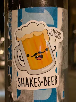 A cute sticker of a beer mug with a mustache.  The text on the sticker says "To beer or not to beer?" and "Shakes-Beer".