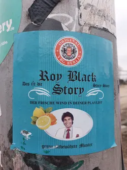 Street sticker A turquoise sticker featuring Roy Black, a German singer. The sticker has text in German and  a logo that says 'Original YBG Berlin'.