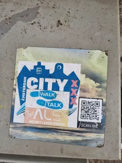A sticker featuring a city logo with the text 'CITY' and 'XXX', along with the words 'WALK', 'TALK', 'ALS', and 'WE HET LEVEN VIEREN'. A QR code is also present, with the instruction 'SCAN ME'.
