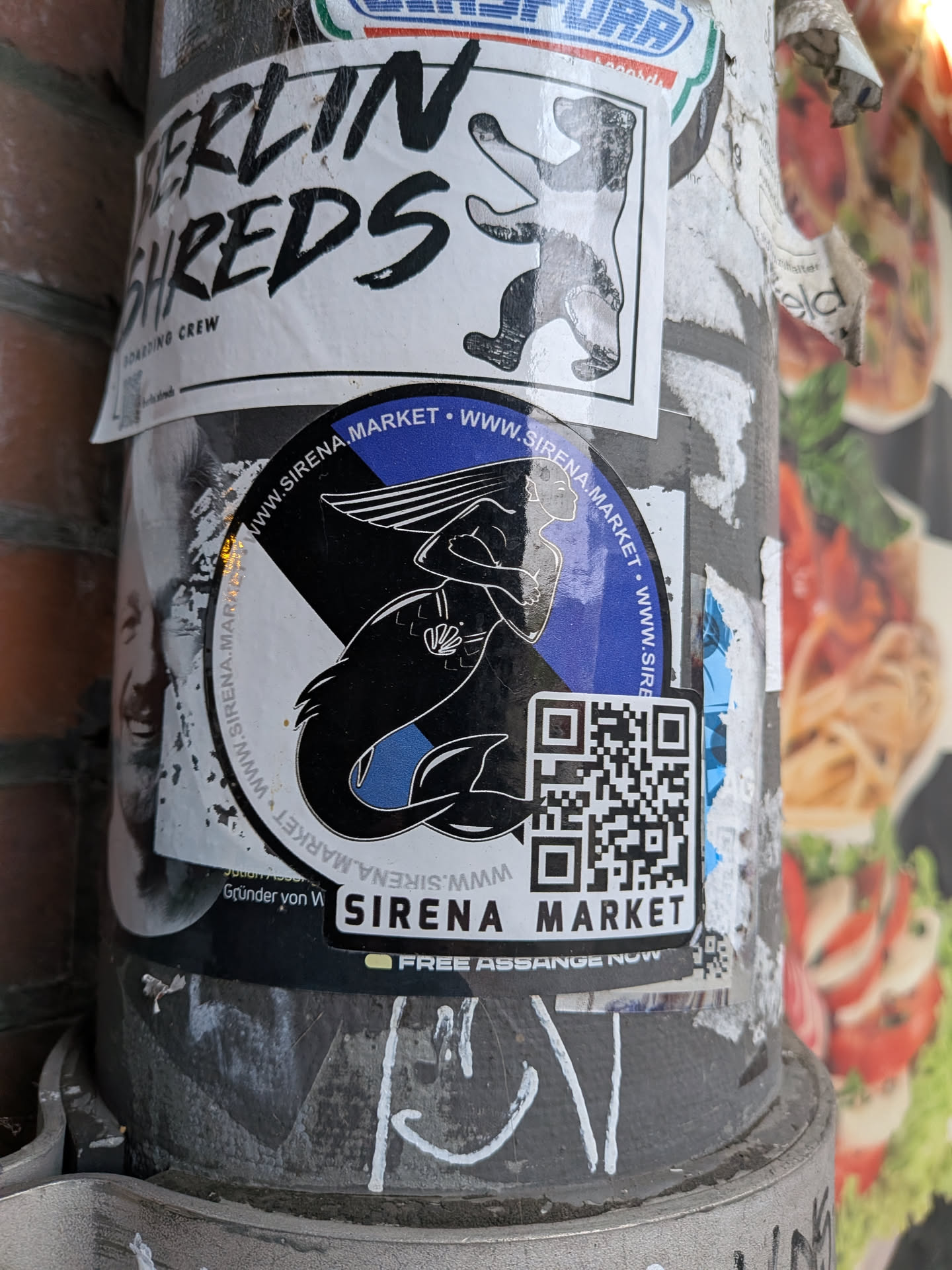 A circular vinyl sticker with an attached rectangular extension at the bottom right. The central artwork displays a stylized black and white illustration of a mermaid with flowing hair and a seashell detail against a split background of cobalt blue and light gray/white. Surrounding the perimeter of the circular section is the repeating web address 'WWW.SIRENA.MARKET'. The lower-right corner features a prominent black-and-white QR code positioned above the label 'SIRENA MARKET' printed in bold, sans-serif uppercase letters.