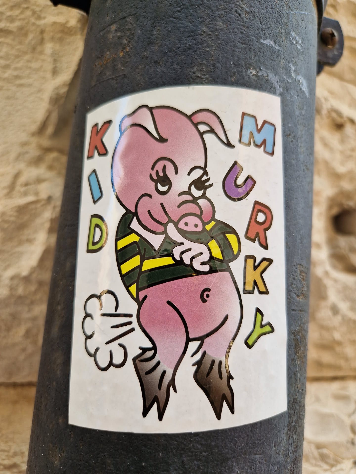 A sticker featuring a cartoon pig in a rugby shirt, farting. The words "KID MURKY" are written vertically on either side of the pig.