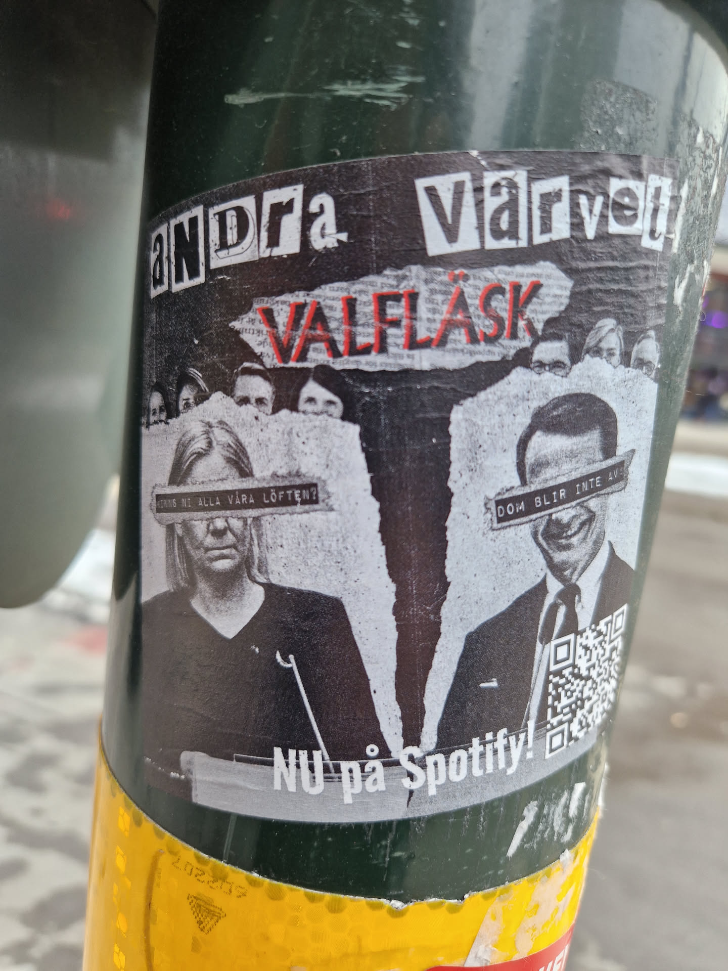 A sticker featuring a stylized image of two individuals, possibly politicians, with text obscuring their eyes. The text 'Andra Varvet' and 'Valflask' is prominently displayed, along with a Spotify promotion.  The design is somewhat collage-like with a ripped paper effect.