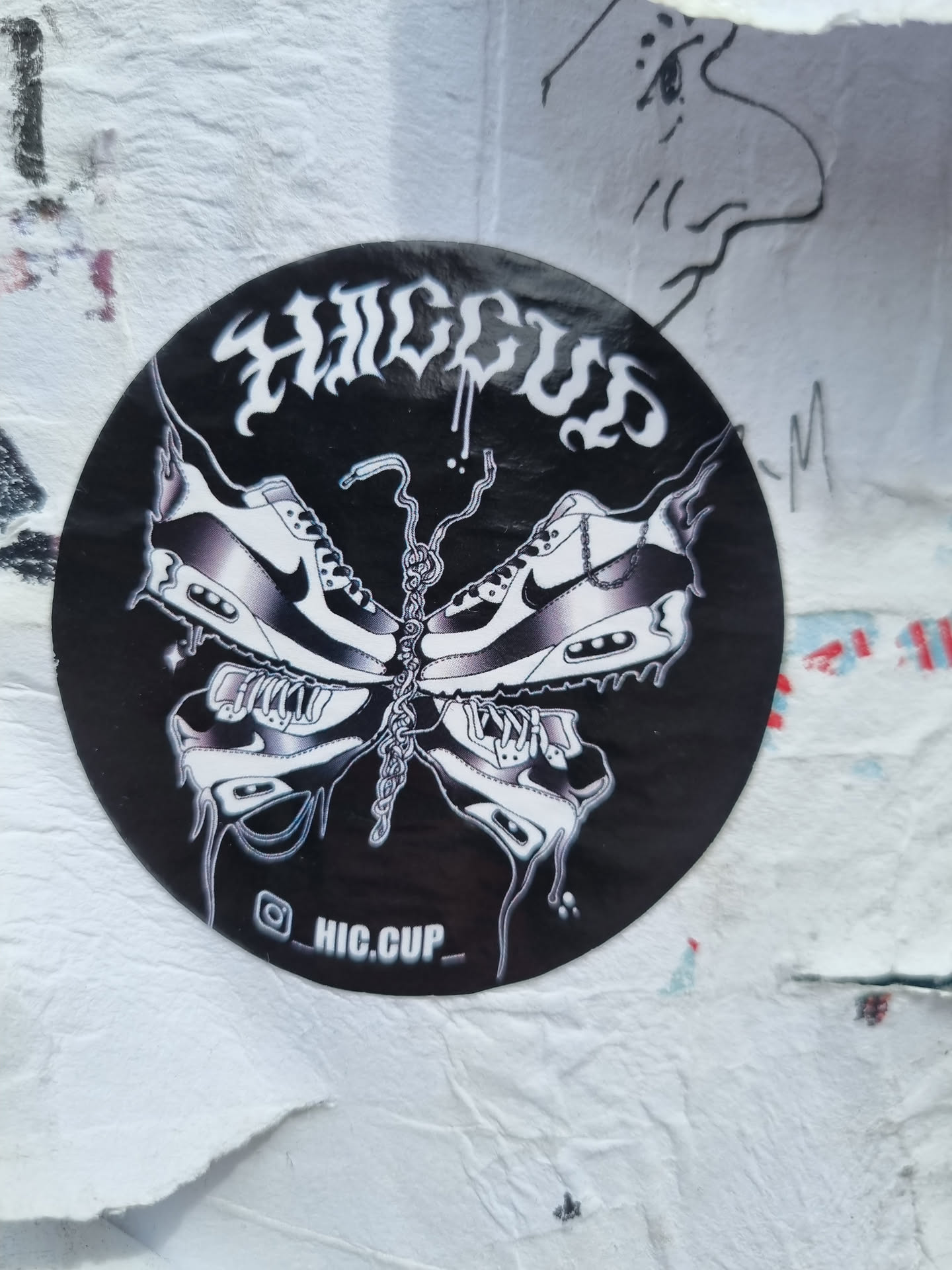 Black and white sticker of a butterfly made of Nike Air Max 90 shoes. The word HIC CUP is written in a stylized font at the top. The sticker has a dripping effect and the Instagram handle @HIC.CUP_ is visible at the bottom.