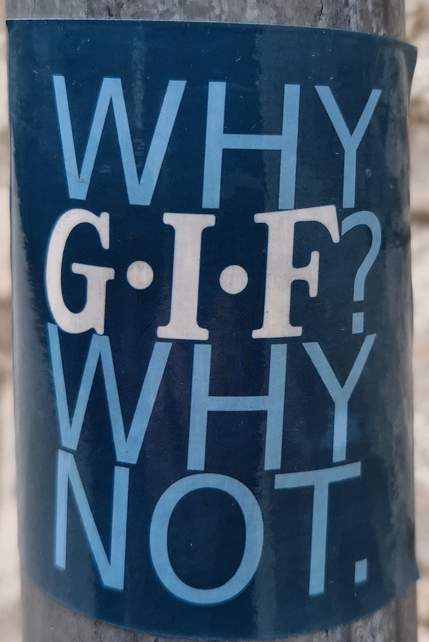 A dark-blue sticker with a question and answer about GIF. The text is written in a sans-serif typeface with a light-blue color.