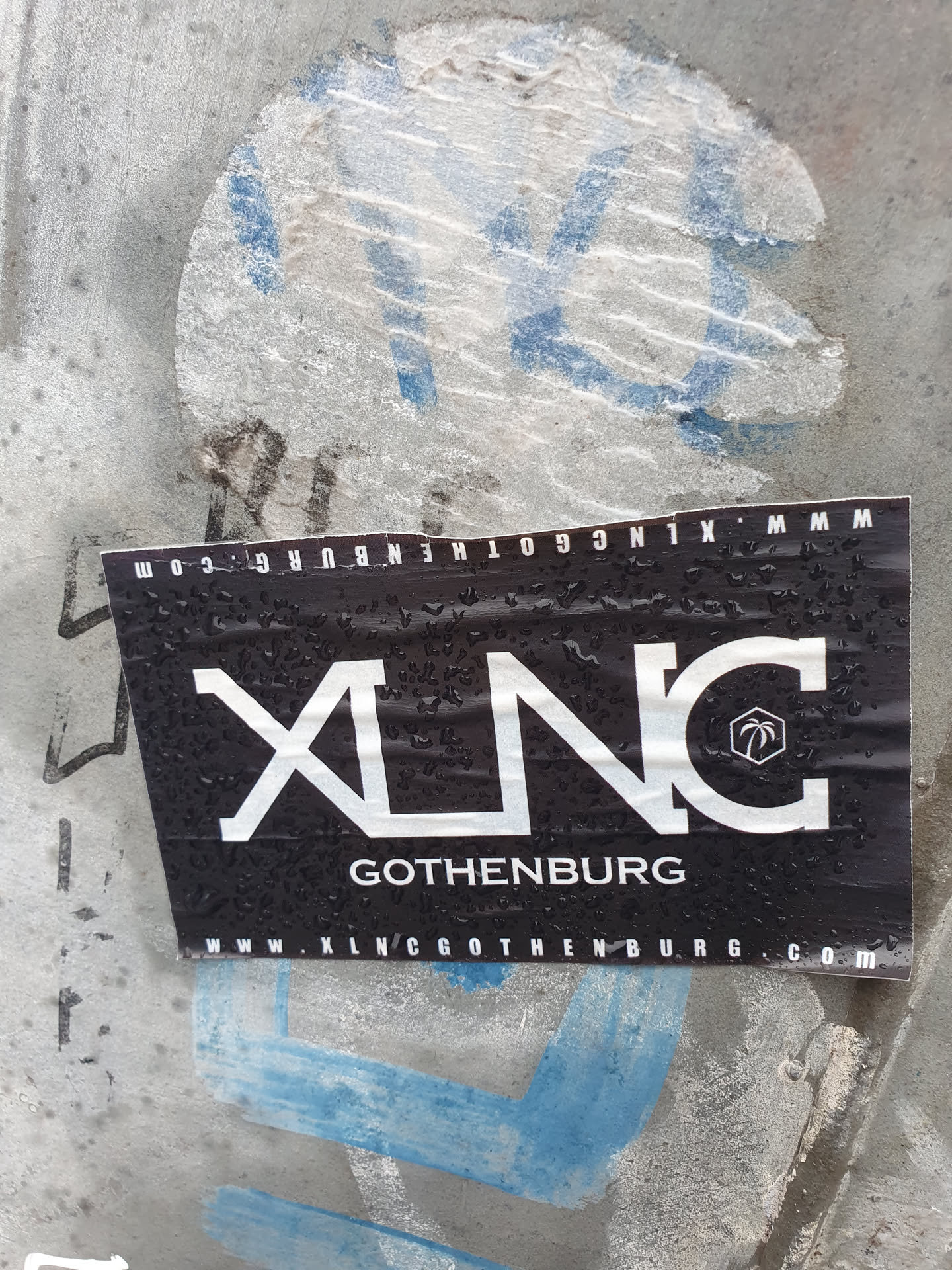 A black and white sticker with the logo XLNC and the text Gothenburg. The website www.xlncgothenburg.com is also printed on the sticker. 